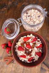 Healthy cereal with strawberry on wooden table