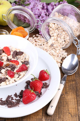 Healthy cereal with fruits on wooden table