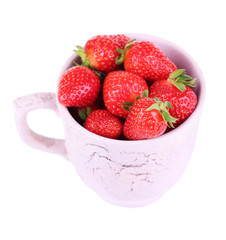 Ripe sweet strawberries in color mug isolated on white