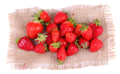 Ripe sweet strawberries on sackcloth napkin isolated on white
