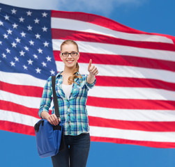 student with laptop bag showing thumbs up