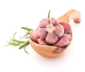 Garlic cloves in wooden bowl isolated on white background