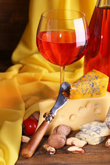 Different kinds of cheese and wine isolated on white