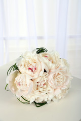 Beautiful wedding bouquet on table on light background