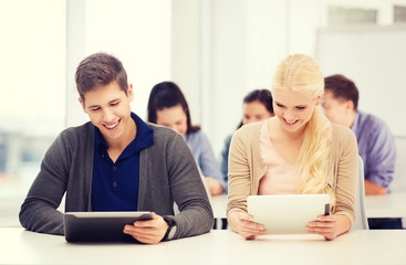 students looking at tablet pc in lecture at school