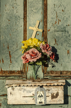 Rustic old doorway flowers and cross