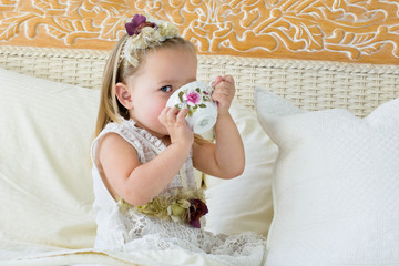 Little girl playing tea party