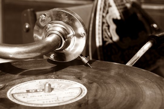 Vintage gramophone with a vinyl. Sepia