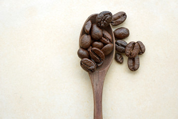 coffee beans on wooden spoon