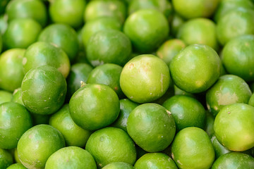 fresh green lemon asia in the market , background blur