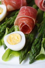 Asparagus with boiled eggs and ham  macro. Vertical