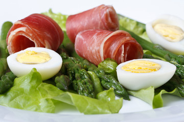 Festive salad of quail eggs with ham and asparagus