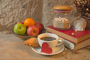 Still life coffee breakfast,apples and old book with seashell de