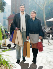  couple with shopping bags at  city street