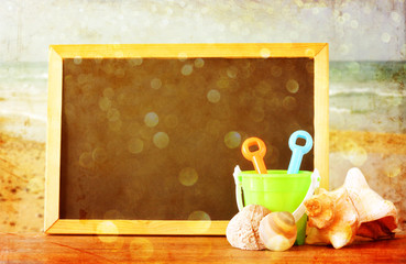 empty blackboard and over beach landscape, summertime concept.