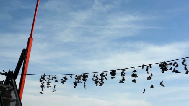 Shoes hanging on a rope with pendulum