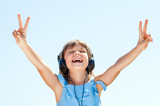 Happy little girl in headphones