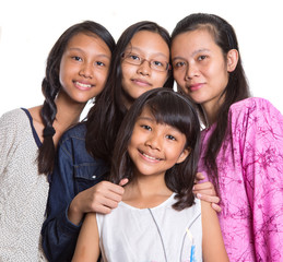 Mother and daughters over white background