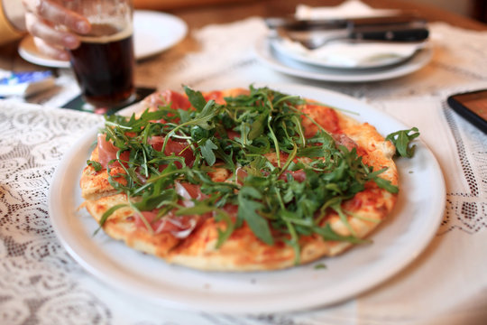 Pizza with meat and arugula