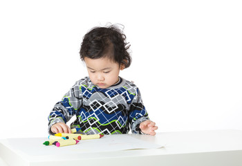 Asia little boy concentrate on drawing