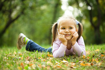Portrait of a little girl in autumn park