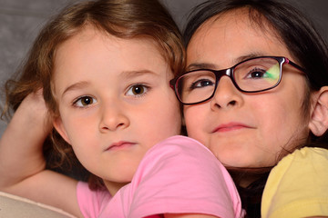 Two little cute sisters posing