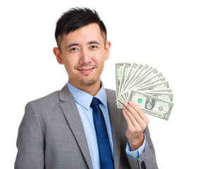 Businessman holding spread of money