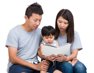 Asian parent reading booking with baby son