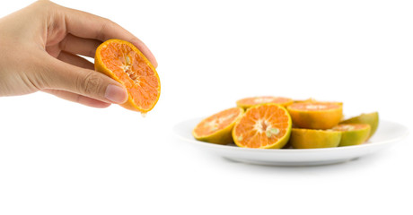 Female hand squeeze juicy orange