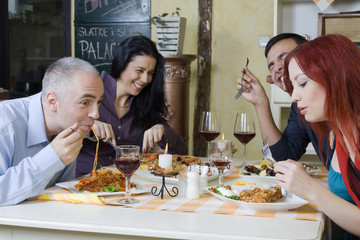 Friends at restaurant have fun.