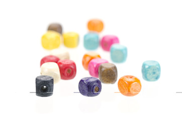 Colorful wooden beads isolated on white background