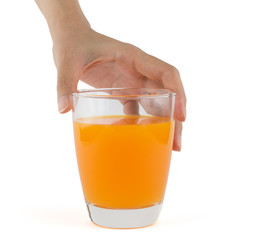 Hand holding a glass of orange juice
