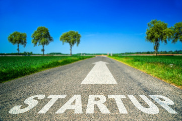 Startup word painted on asphalt road
