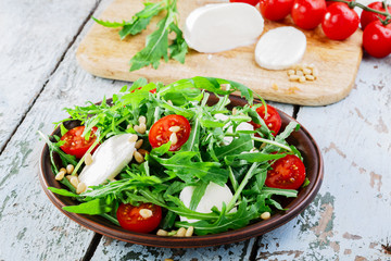 arugula salad with mozzarella cheese and cherry tomatoes