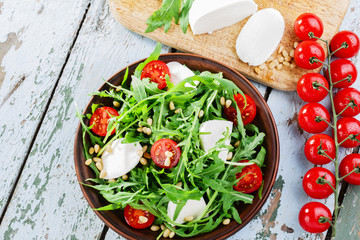 arugula salad with mozzarella cheese and cherry tomatoes