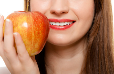 Diet. Girl offering apple seasonal fruit.