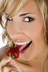 Portrait of a sexy girl eating strawberry 