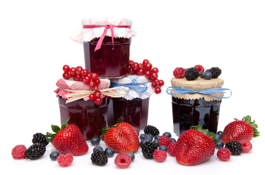 Composition with jars of red and black fruits jams