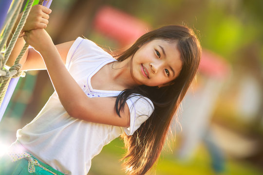 Happy Little Asian Girl On The Playground