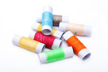 Fototapeta na wymiar small variety color spools of threads pile