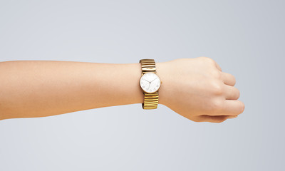 Hand with watch showing precise time