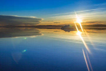 The melting iceberg on spring mountain lake in the setting sun. © cherniyvg