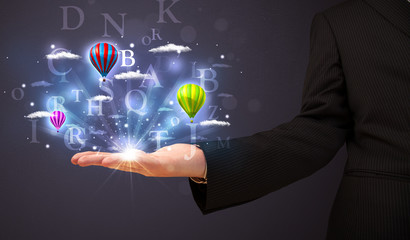 Letters and balloons in the hand of a businessman