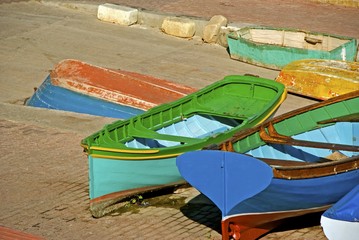 Richly colored boats for fishing in a small harbor.