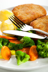 Fried pork chop with boiled potatoes and vegetables