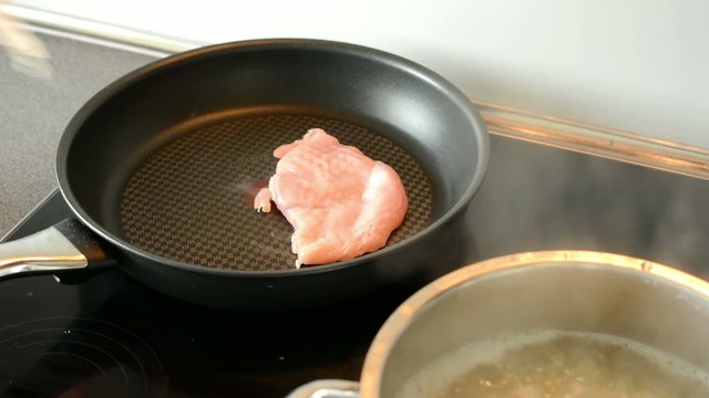 man cook meat - put meat to the pan