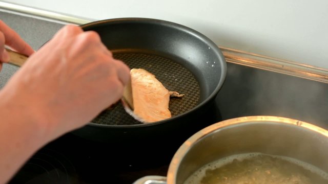 man cook meat - turning meat