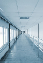 Long corridor with door at end.