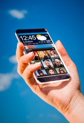 Smartphone with transparent screen in human hands.