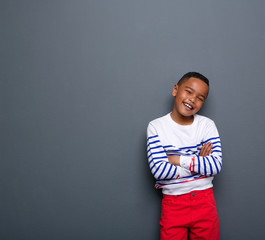 Cute little boy smiling with arms crossed © mimagephotos